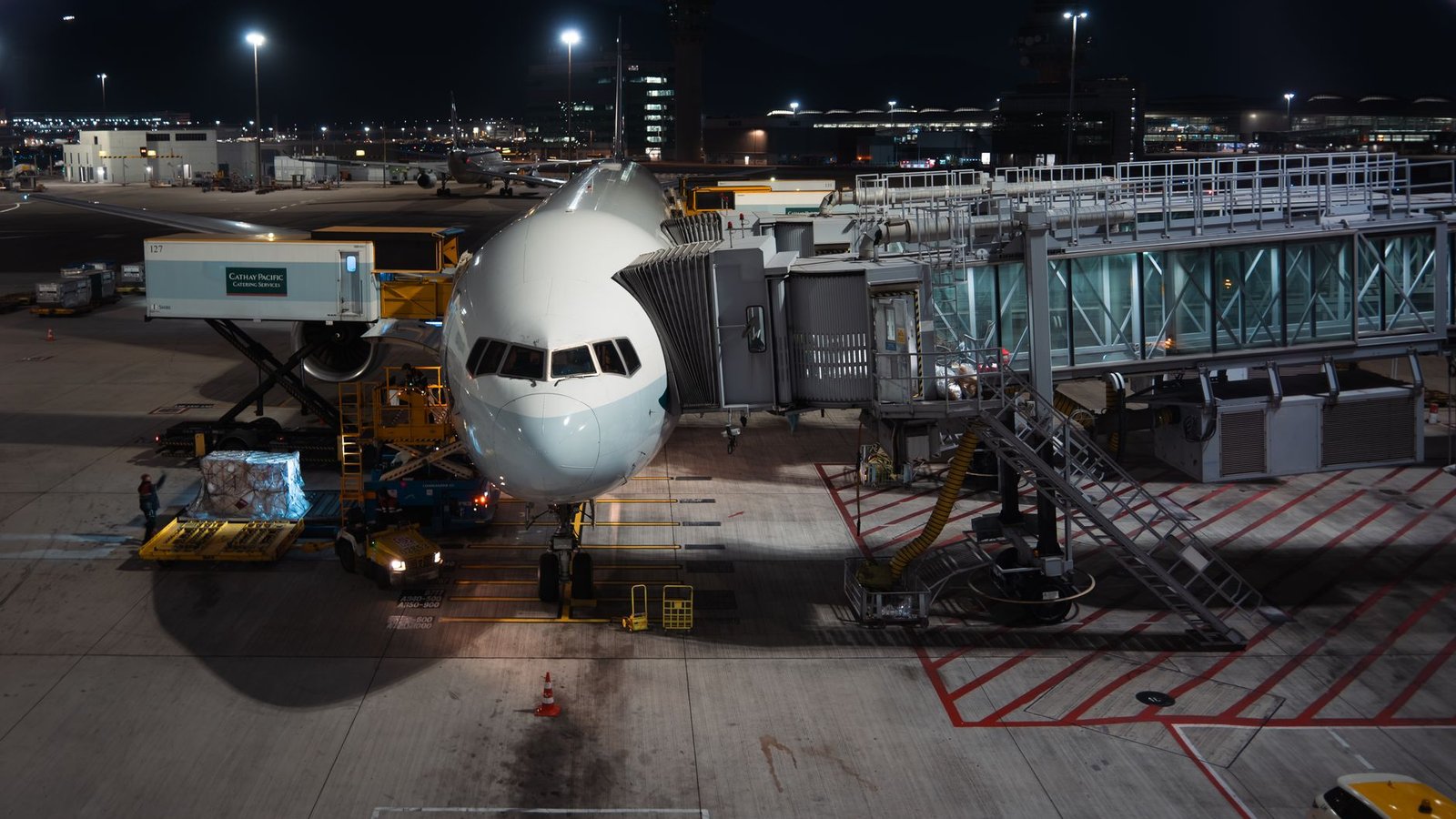 Chargement de conteneurs de fret dans la soute d'un avion de ligne sur le tarmac